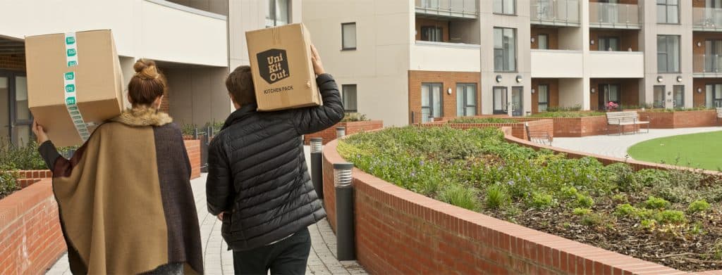 Students Carrying UniKitOut boxes