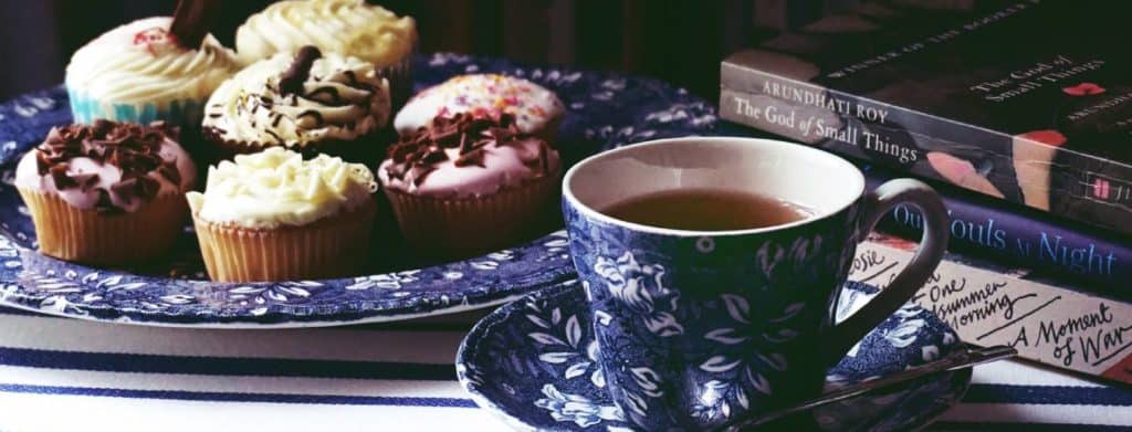 cup of tea cupcakes and books to look after mental health and wellbeing
