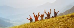 group of students outside on hillside happiness