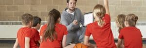 Coach-Giving-Team-Talk-To-Children-Basketball