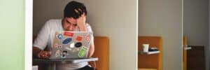 Man-looking-stressed-Using-Macbook-Pro