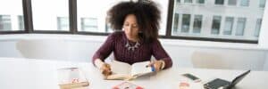 Woman-Reading-Book-While-Sitting
