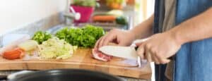 person preparing fresh food from meal box